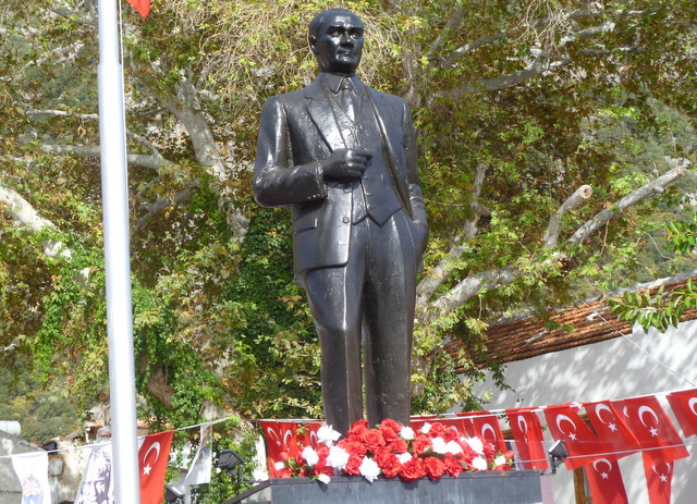 Statue of AtatÃ¼rk on main square of KaÅŸ is adorned with flowers in honor of his birthday