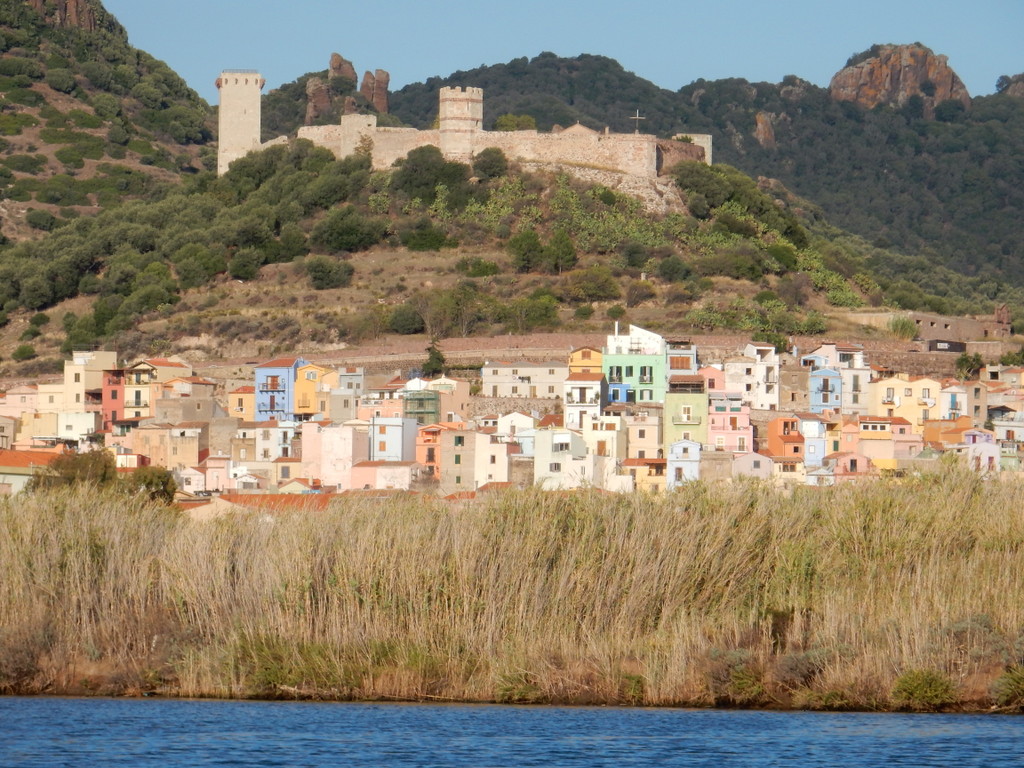 View of the river city of Bosa (Sardinia) as we come up the River Temo in our dinghy. The Malaspina Castle overlooks the city.